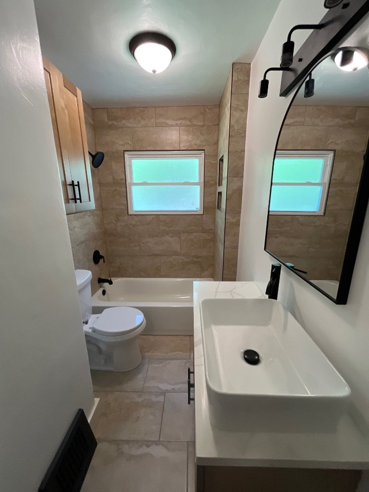 Bathroom remodel by RemodelCo in Salt Lake City, UT featuring a vessel sink vanity and tiled bathtub